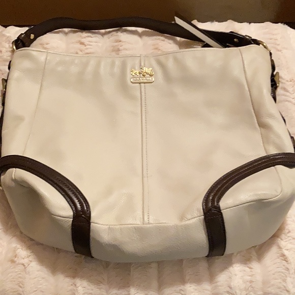 This is a cream color, medium size Coach handbag. - Picture 2 of 3